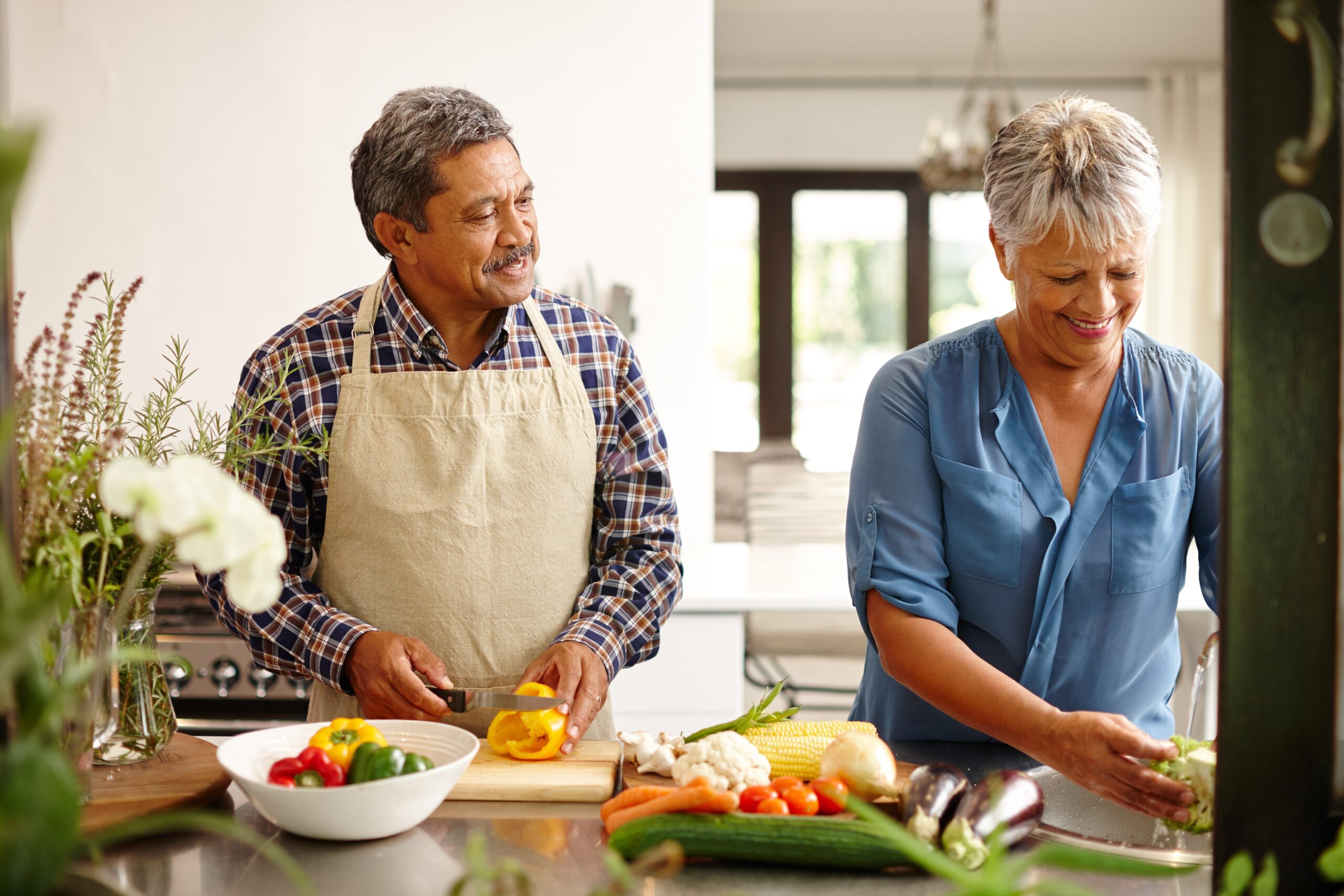 older couple cooking healthy food together to prevent blood clots according to experts at vein solutions flint in michigan