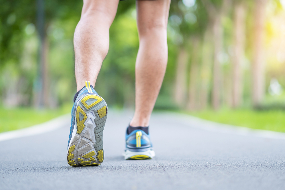 A person walking while wearing running shoes.